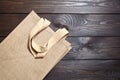 Reusable shopping bag, natural textile fiber, eco hessian or jute sack on brown wooden background Royalty Free Stock Photo