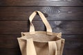Reusable shopping bag, natural textile fiber, eco hessian or jute sack on brown wooden table Royalty Free Stock Photo