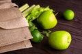 Reusable shopping jute bag with fresh fruits and greens on wooden background Royalty Free Stock Photo