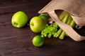 Reusable shopping jute bag with fresh fruits and greens on wooden background Royalty Free Stock Photo