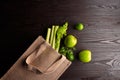 Reusable shopping jute bag with fresh fruits and greens on wooden background Royalty Free Stock Photo