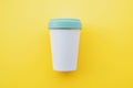 Reusable stylish eco-friendly bamboo cup for take away coffee on yellow background