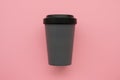 Reusable stylish eco friendly grey bamboo cup on pink background.