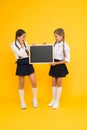 A reusable writing surface. Little children preparing blackboard for lesson. Small pupils with school blackboard. Cute Royalty Free Stock Photo