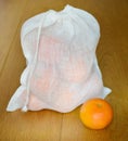 Reusable zero waste linen produce bag with mandarin fruits