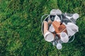 Reuse garbage, recycle, plastic free. Food plastic packaging in trash bin on green moss background after picnic in