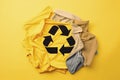 Reuse, reduce, recycle concept background. Recycle symbol made from old clothing on yellow background Royalty Free Stock Photo