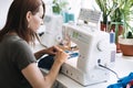 Reuse, repair, upcycle. Denim upcycling ideas, repair and using old jeans. Close-up of sewing machine with shabby, old Royalty Free Stock Photo