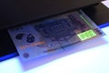 Money banknote UV testing. Security features check.