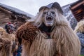 Reveller wearing wooden mask and carnival costume in Switzerland