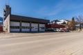 REVELSTOKE, CANADA - MARCH 16, 2021: small town fire hall street view with cars and canadian flag