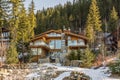 REVELSTOKE, CANADA - MARCH 16, 2021: Wooden mountain house in the forest between tall trees