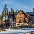 REVELSTOKE, CANADA - MARCH 16, 2021: Wooden mountain house in the forest between tall trees