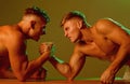 Revenge in sport. Twins men competing till victory. Strength skills. Twins competitors arm wrestling. Men competitors