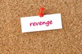 Revenge. Word written on a piece of paper, cork board background