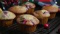 Revers dolly shot with homemade cranberry orange muffins on cooling rack, Christmas decoration on background