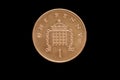 Reverse of the Great Britain one penny coin of 1996 isolated on a black background Royalty Free Stock Photo