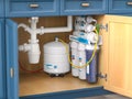 Reverse osmosis water purification system under sink in a kitchen. Water cleaning system installation