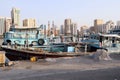 The reverse side of the capital seaport. A small wooden private no name broken merchant boats with waste against of urban