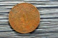 Reverse side of an old 1 One Egyptian red millieme coin year 1950, translation of Arabic text (Egyptian Kingdom,1 Millieme,