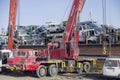 The reverse side of the seaport. A small private no name merchant ship unloads old used cars