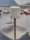 Reversed plastic bucket over a turned boat in harbor. Royalty Free Stock Photo