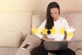 Review concept, five stars, Young woman with laptop. Rate your experience with star icons