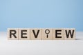 Review headline sign on wooden cubes on table. Review evaluation time for review inspection assessment auditing. Learning, Royalty Free Stock Photo