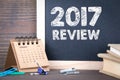 2017 review. paper calendar and chalkboard on a wooden table