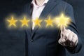 Review and rating increase company concept, Businessman hand touching five star. evaluation and classification concept. Royalty Free Stock Photo