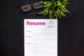 Review resumes of applicants set with glasses black work desk background top view