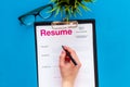 Review resumes of applicants set with glasses blue work desk background top view