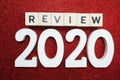 Review 2020 word alphabet letters on red glitter background