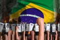 Protest in Brazil - police guards stand against the demonstrators crowd on flag background, riot fighting concept, military 3D