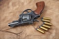 Revolver with ammunition on the wooden table Royalty Free Stock Photo