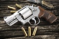 Revolver hand gun and ammunition on wooden background Royalty Free Stock Photo