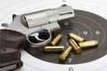 Revolver hand gun and bullets on bull eye target background Royalty Free Stock Photo