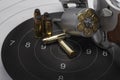 Revolver hand gun with bullets on bull eye target paper background Royalty Free Stock Photo