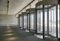 Revolving doors. The facade of a modern shopping center or station, an airport with revolving doors. Royalty Free Stock Photo