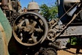 Revolving fly wheel of an old steam powered engine tractor Royalty Free Stock Photo