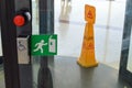 Revolving glass door shopping center building three-door structure anchored rotating on a vertical axis and orange sign wet floor Royalty Free Stock Photo