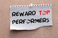 Reward top performers text memo written on a white background with pencils.