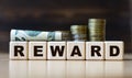 REWARD word on diced on a beautiful dark background with coins Royalty Free Stock Photo