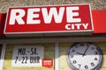 Rewe City logo sign and opening times of german supermarket chain Royalty Free Stock Photo