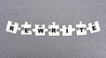 REWRITE - word composed of paper white puzzles on a gray background