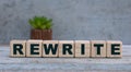 REWRITE word on cubes on an old gray background with cactus