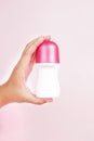 The Rexona product is held in hand against a pink background, creating a soft yet energetic visual Royalty Free Stock Photo