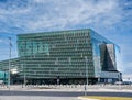 Horizontal view of the distinctive colored glass facade of the Harpa Reykjavik Concert Hall and