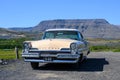 Old vintage Lincoln automobile against icelandic mountain on background