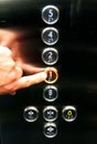 Touching the elevator buttons with Roman alphabet and Braille letters Royalty Free Stock Photo